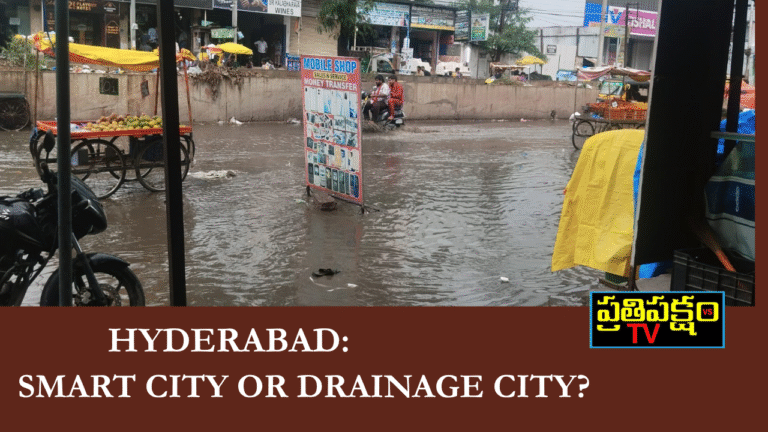 Flooded road near Gudimalkapur, Hyderabad after light rain — drainage water overflowing with vendors and pedestrians struggling